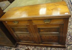 An Edwardian mahogany sideboard of two short drawers and two cupboard doors,