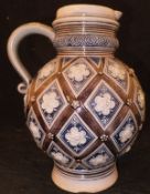 A Merkelbach & Wick of Grenzhausen glazed stoneware jug with lozenge / flower head medallion