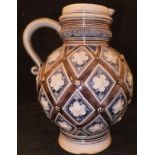 A Merkelbach & Wick of Grenzhausen glazed stoneware jug with lozenge / flower head medallion