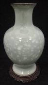 A Japanese celadon wireless cloisonne baluster shaped vase with scrolling foliate and flower head