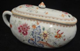A 19th Century Chinese famille rose porcelain bourdaloue and cover decorated with a floral garden