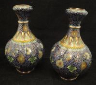 A pair of Chinese cloisonne gourd shaped vases with all-over scrolling foliate and floral
