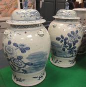 A pair of Chinese blue and white baluster shaped vases with floral decoration and relief work masks