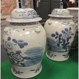 A pair of Chinese blue and white baluster shaped vases with floral decoration and relief work masks