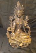 A Chinese or Tibetan hollow cast bronze figure of Arya Tara seated with hands in the gesture of
