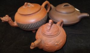 A Chinese Yi Xing teapot, the lid with lizard finial, the spout with grotesque mask decoration,