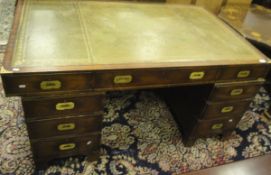 A military style mahogany pedestal partner's desk of nine drawers and green leather inset top,