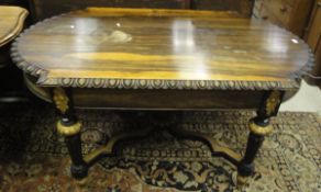 A 19th Century rosewood centre table with egg and dart moulded edge on an ebonised and gilt
