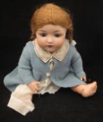 An Armand Marseille Bisque headed doll with composition body, arms and legs,