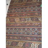 A Kilim rug of multi-striped design with blue, yellow, red and brown colours,