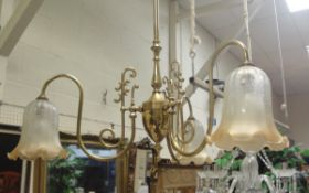 A pair of Christopher Wray brass three branch electroliers with glass shades,
