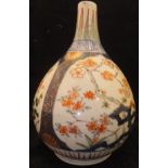 A Japanese Arita bottle vase of gourd form, decorated with panels of blossom,