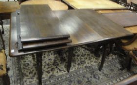 An OKA "Charlotte" style beech extending dining table with four additional leaves on turned legs