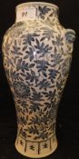 A Chinese blue and white baluster shaped vase with all-over scrolling floral and foliate decoration,