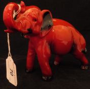A Royal Doulton Flambé figure of an elephant with raised trunk in salute CONDITION