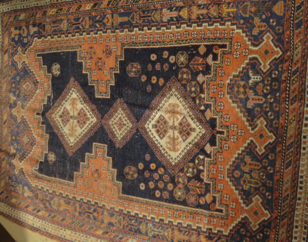 A Caucasian rug, the three central diamond shaped linked medallions in cream,