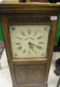 A Wood Brothers (Furniture Limited) "Old Charm" wall clock with Westminster chimes in a linenfold