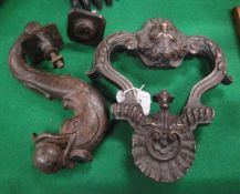 A cast iron "Dolphin and ball" door knocker and a bronze lion mask door knocker
