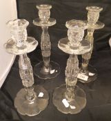 A set of four early 20th Century cut glass candlesticks with hollow centres