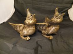 A pair of silvered bronze mounts or furniture feet as dragons with spread wings