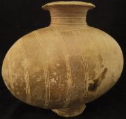 A Chinese Han Dynasty pottery cocoon jar with incised ring decoration,