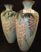 A pair of Meiji Period Japanese cloisonne vases decorated with pendant wisteria on a pale blue