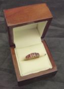 A 9 carat gold and ruby set dress ring