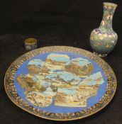 A Chinese cloisonne plate decorated with eight various panels depicting landscape scenes with