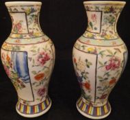 A pair of Chinese polychrome decorated baluster shaped vases,