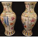 A pair of Chinese polychrome decorated baluster shaped vases,