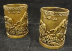 A pair of Japanese bronze cylindrical vases with relief work decoration of tigers in a landscape