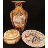 A Meiji period Japanese Satsuma ware pot and cover decorated with exotic birds amongst scrolling