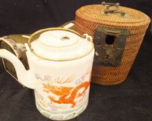 A Chinese porcelain cylindrical teapot with five toed dragon decoration, housed in a basket case,