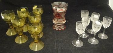 A 19th Century Bohemian ruby overlaid glass beaker decorated with various panels of flowers and