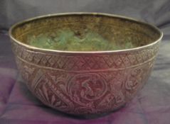 A white metal Chinese possibly Tibetan bowl with embossed decoration depicting deities and stylised