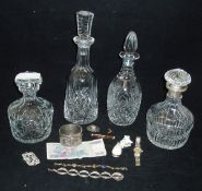 Four assorted cut glass decanters to include one with a silver collar together with a small