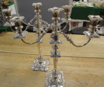 A pair of plated on copper two branch three light candelabra
