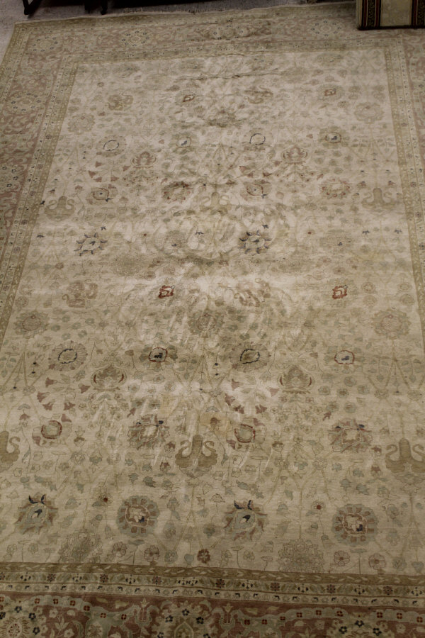 A modern Persian design rug, the central panel set with all-over floral design on a cream ground,