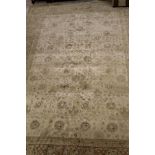 A modern Persian design rug, the central panel set with all-over floral design on a cream ground,