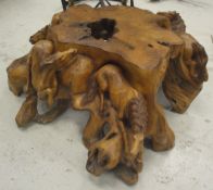 A modern carved rootwood table decorated with prancing horses