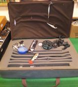 A fisherman's compedium contained in a travel case containing a Cabelas fixed spool reel,