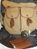 A Brady canvas and leather shoulder bag containing an assortment of leather and wrexine fly wallets,