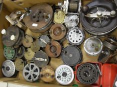 An assorted collection of 27 fishing reels to include brass trout reels, wooden reels,