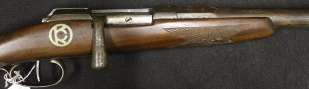A 12 bore bolt action shotgun with single 30½" barrel, bears "OKC" inlaid medallion to stock (No.
