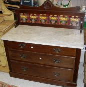 A Victorian mahogany marble top tile back wash stand with three long drawers on a plinth base
