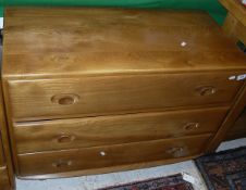 An Ercol elm dwarf chest of three long drawers CONDITION REPORTS Some marks,