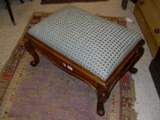 A Victorian walnut framed rectangular stool with drop-in upholstered seat on cabriole legs to