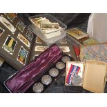 A box containing assorted cigarette cards, a cased set of five white metal buttons,