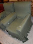Two Victorian upholstered armchairs with matching green loose covers