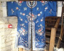 An early 20th Century Chinese silk robe with floral motifs all over,